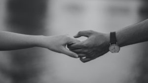 A couple holding hands.