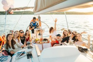 Women enjoying wine and fruits on a luxury yacht