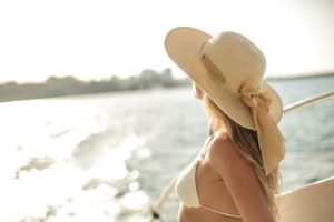 Woman with a hat on a yacht party