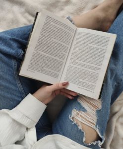 woman reading novel on vacation
