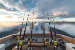 4 fishing rods attached to a yacht