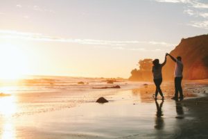 A couple holding hands on a beach