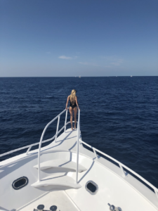 A woman going for a dive from a luxury performance sport yacht