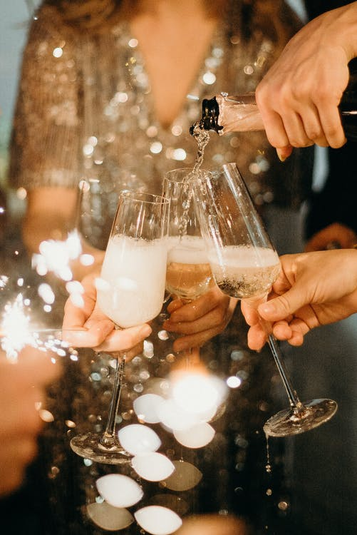 Champagne glasses are being filled.