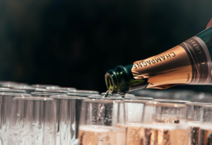 Champagne bottle filling the glasses