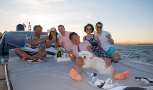An image showing a group of people enjoying on a yacht by Cabo Yacht World